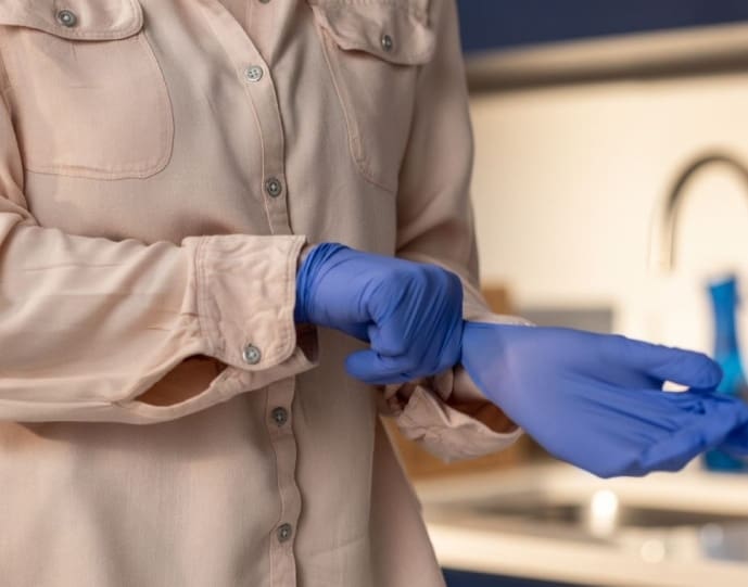 Image of plastic gloves being put on