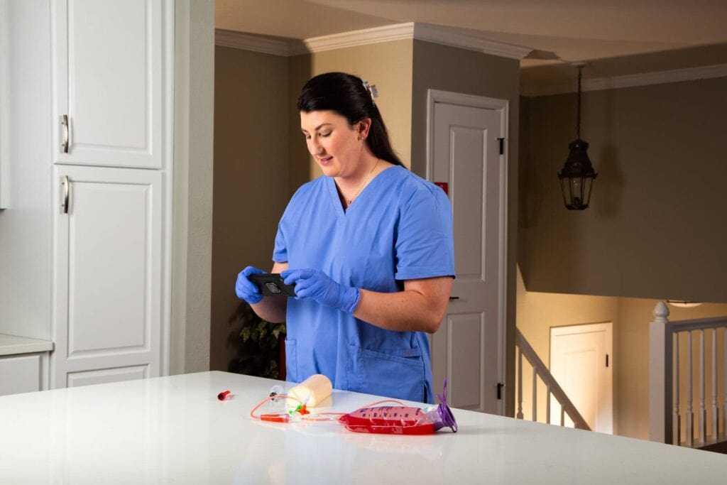 student in her kitchen with MA equipment on the counter